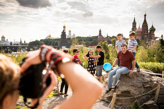 People take pictures with the Saint Basil's Cathedral in
