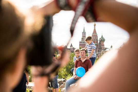 People take pictures with the Saint Basil's Cathedral in