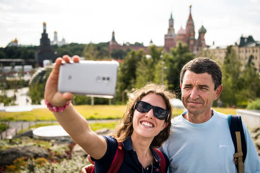 People take pictures with the Saint Basil's Cathedral in