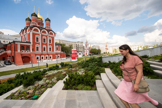 People are seen walking in a park in central Moscow