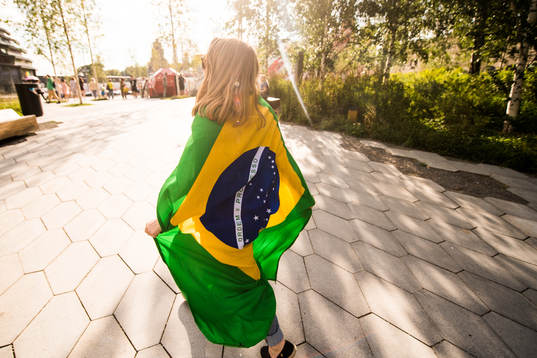 A fan of Brazil are seen walking in a park in central Moscow