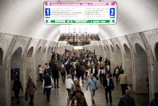Passengers walk at a metro station