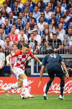 Ivan Perisic of Croatia challenges Raphael Varane of France