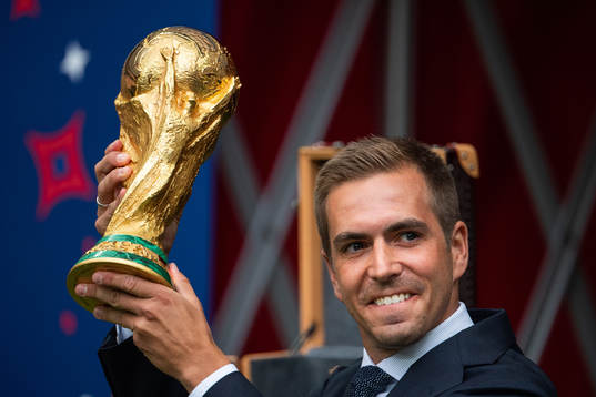 Philipp Lahm brings the World Cup Trophy in to the stadium