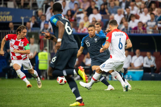 Kylian Mbappe of France competes for the ball with Dejan
