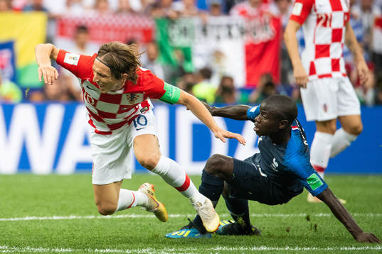 Luka Modric of Croatia falls in a duel with Ngolo Kante of