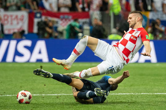 Ante Rebic of Croatia falls in a duel with Lucas Hernandez