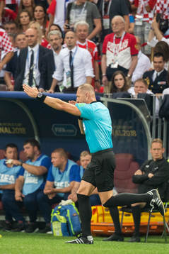 Referee Nestor Pitana signals for penalty for France