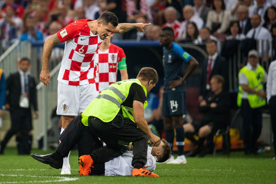 Dejan Lovren of Croatia and a steward in a situation with