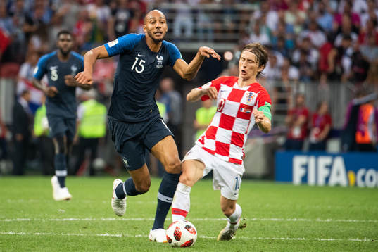 Steven Nzonzi of France falls in a duel with Luka Modric of