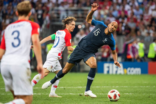 Steven Nzonzi of France falls in a duel with Luka Modric of
