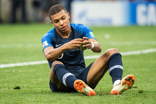 Kylian Mbappe of France with a piece of grass in his hands