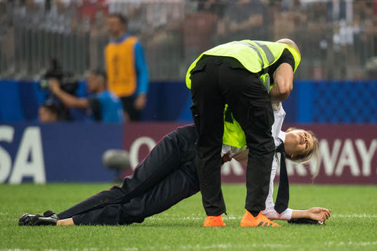 A Steward holds apitch invader