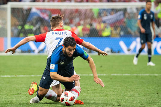 Nabil Fekir of France falls in a duel with Ivan Rakitic of