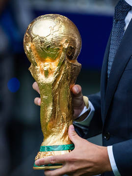 Philipp Lahm brings the World Cup Trophy in to the stadium