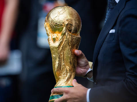 Philipp Lahm brings the World Cup Trophy in to the stadium