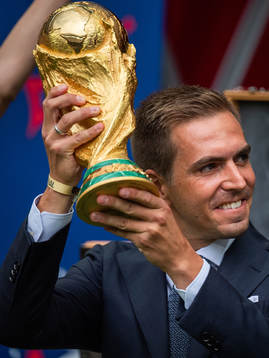 Philipp Lahm brings the World Cup Trophy in to the stadium