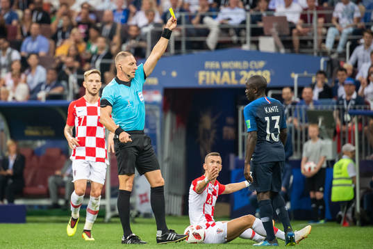 Ngolo Kante of France gets a yellow card from referee