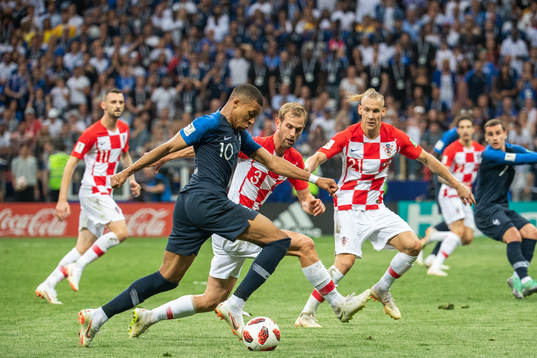 Kylian Mbappe of France challenges Ivan Strinic of Croatia