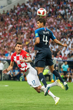 Mario Mandzukic of Croatia and Raphael Varane of France