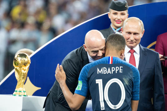FIFA president Gianni Infantino hugs Kylian Mbappe of France