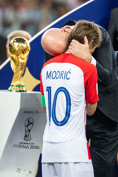 FIFA president Gianni Infantino hugs Luka Modric of Croatia