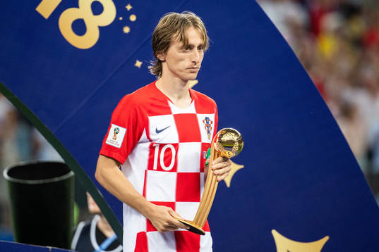 Luka Modric of Croatia with the award to the best player of