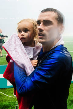 Antoine Griezmann of France celebrates together with a child