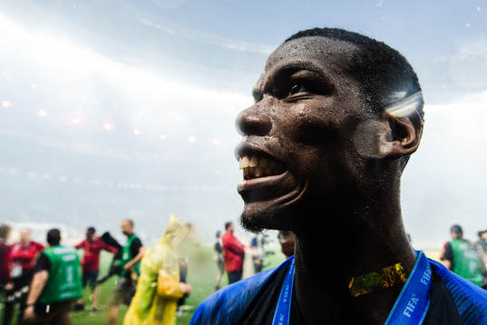 Paul Pogba of France celebrates with the gold medal around