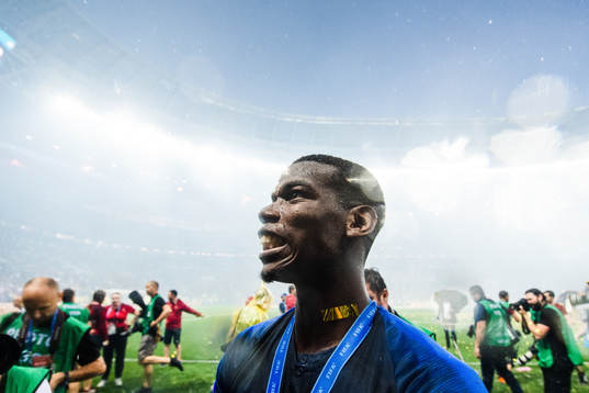 Paul Pogba of France celebrates with the gold medal around
