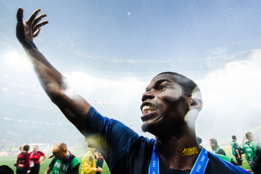 Paul Pogba of France celebrates with the gold medal around