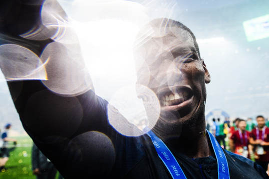 Paul Pogba of France celebrates with the gold medal around
