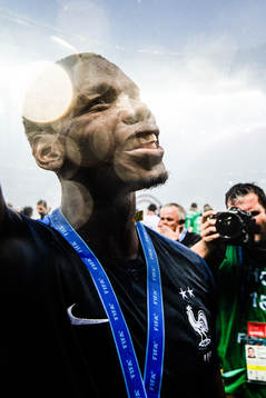 Paul Pogba of France celebrates with the gold medal around