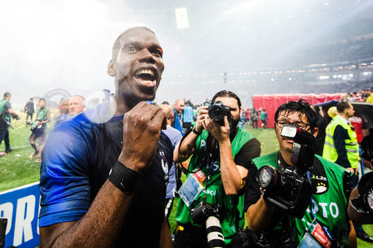 Paul Pogba of France celebrates with the gold medal around