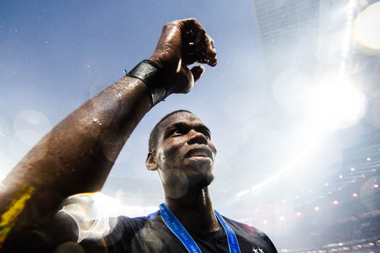 Paul Pogba of France celebrates with the gold medal around