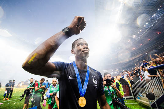 Paul Pogba of France celebrates with the gold medal around