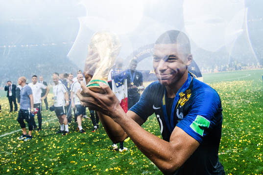 Kylian Mbappe of France celebrates with the trophy