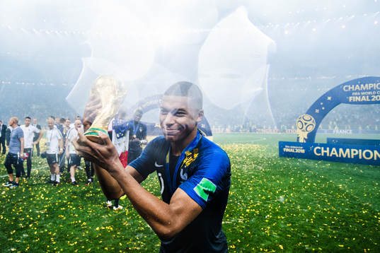 Kylian Mbappe of France celebrates with the trophy
