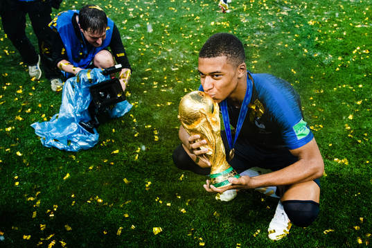 Kylian Mbappe of France celebrates with the trophy