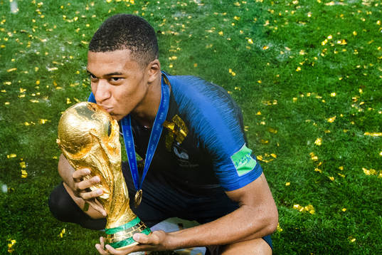 Kylian Mbappe of France celebrates with the trophy