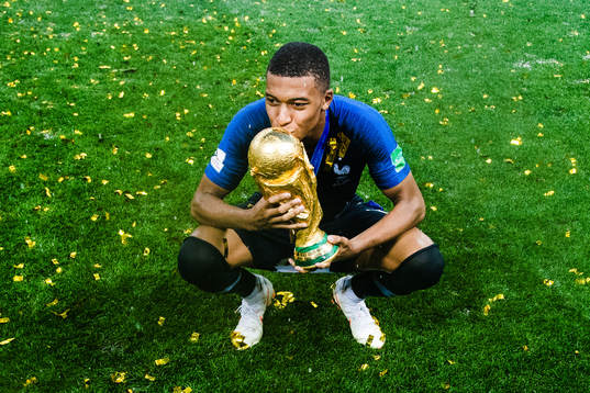 Kylian Mbappe of France celebrates with the trophy