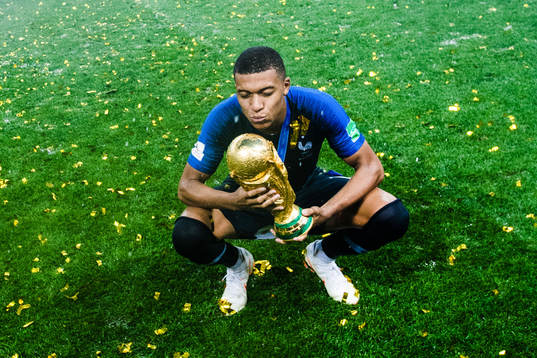 Kylian Mbappe of France celebrates with the trophy