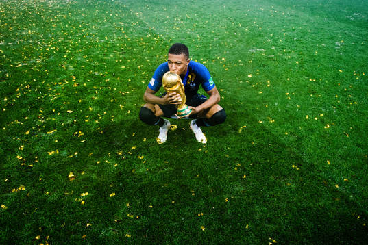Kylian Mbappe of France celebrates with the trophy