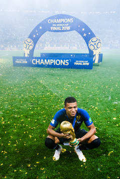 Kylian Mbappe of France celebrates with the trophy