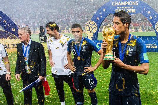 Raphael Varane of France celebrates with kissing the trophy