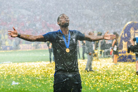 Paul Pogba of France celebrates with the gold medal around