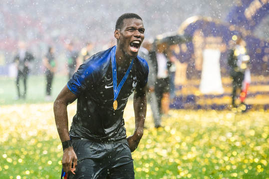 Paul Pogba of France celebrates with the gold medal around