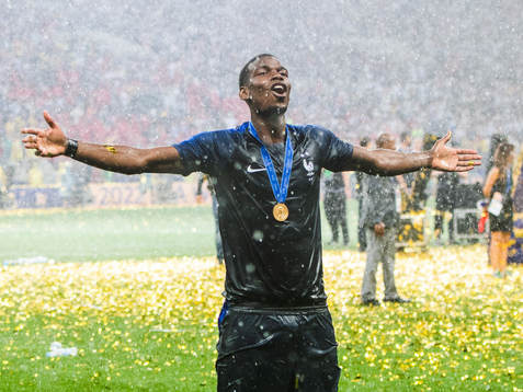 Paul Pogba of France celebrates with the gold medal around