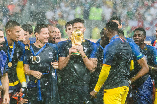 Olivier Giroud of France kisses the trophy while he and