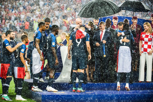 Olivier Giroud of France receives his gold medal from FIFA